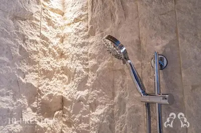 a shower head on a wall in a bathroom at Alpenglow Cortina Luxury in Cortina dʼAmpezzo