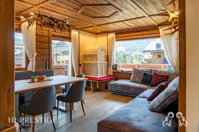 a living room with a table and a couch at Alpenglow Cortina Luxury in Cortina dʼAmpezzo