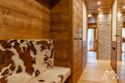 a cow print couch in a room with wooden walls at Alpenglow Cortina Luxury in Cortina dʼAmpezzo