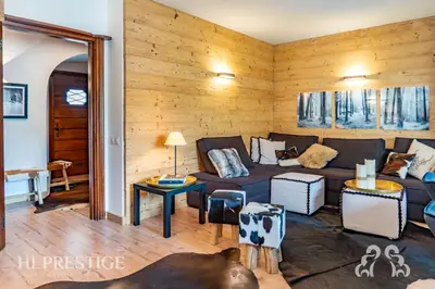 a living room with a couch and a table at Olimpic Cà di Bosco in Cortina dʼAmpezzo