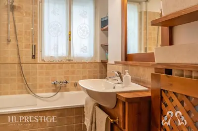 a bathroom with a sink and a shower and a tub at Olimpic Cà di Bosco in Cortina dʼAmpezzo