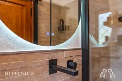 a bathroom with a mirror on the wall at Olimpic Cà di Bosco in Cortina dʼAmpezzo