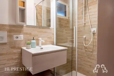 a bathroom with a sink and a shower at Olimpic Cà di Bosco in Cortina dʼAmpezzo