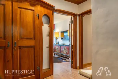 a hallway with a wooden door in a house at Olimpic Cà di Bosco in Cortina dʼAmpezzo