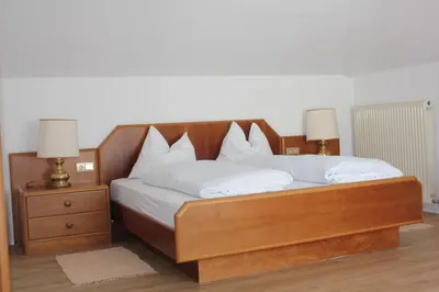 a bedroom with a bed with a large window at Hotel Annabell in Merano