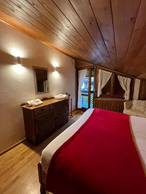 a bedroom with a bed and a vanity and a sink at Apartment 5 Torri, parcheggio in garage in Cortina dʼAmpezzo