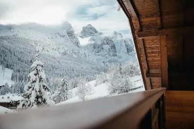 a room with a view of a snow covered mountain at ELMA Corvara in Corvara in Badia