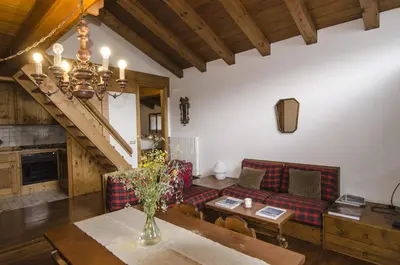 a living room with a couch and a table at Comfort a due passi dal centro in Cortina dʼAmpezzo