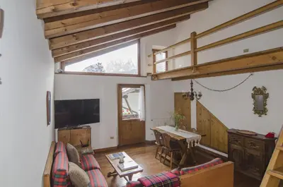 a living room with a couch and a table at Comfort a due passi dal centro in Cortina dʼAmpezzo