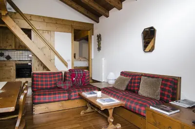 a living room with two couches and a table at Comfort a due passi dal centro in Cortina dʼAmpezzo
