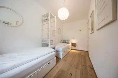 a white room with a bed and a shelf at Panorama Apartment in Nalles