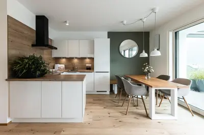 a kitchen and dining room with a table and chairs at Panorama Apartment in Nalles