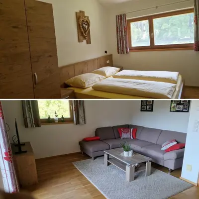 a bedroom and a living room with a couch and a bed at Frunhaus - Zimmer, Apartments, Ferienwohnungen in Fiumes