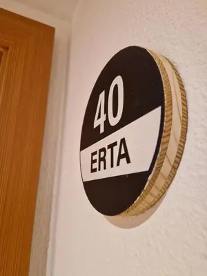 a sign on a wall with the number extra at Apartments Angela in San Vigilio Di Marebbe