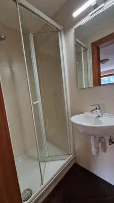 a bathroom with a shower and a sink at Apartments Angela in San Vigilio Di Marebbe
