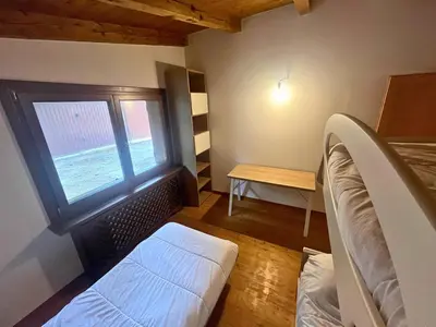 a small room with a bed and a window at Relax & Elegance apartment near Cortina in San Vito di Cadore