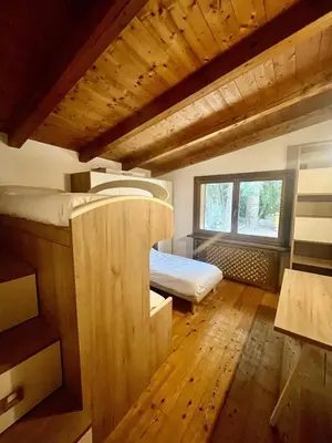 a room with two bunk beds and a window at Relax & Elegance apartment near Cortina in San Vito di Cadore