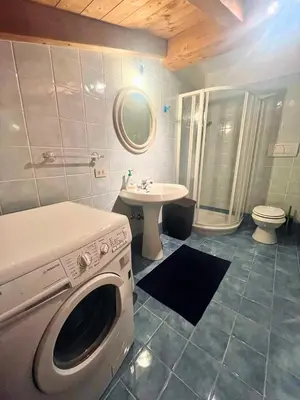 a washing machine in a bathroom with a sink at Relax & Elegance apartment near Cortina in San Vito di Cadore