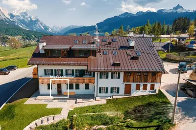 an aerial view of a house with mountains in the background at Rifugio Tofane - Dolomiti Skyline in Cortina dʼAmpezzo