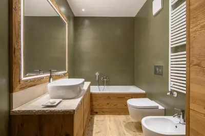 a bathroom with a sink and a tub and a toilet at Rifugio Tofane - Dolomiti Skyline in Cortina dʼAmpezzo