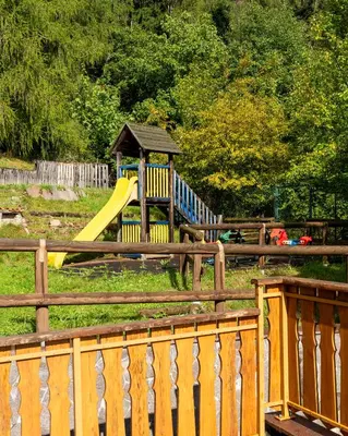 a playground with a yellow slide and a slideintend at El Casel dei Masi in Grumes