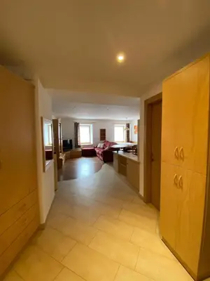 a hallway with a living room and a dining room at El Polse - Appartmento per 5 persone in Ziano di Fiemme