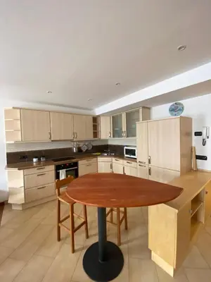 a large kitchen with a wooden table in it at El Polse - Appartmento per 5 persone in Ziano di Fiemme