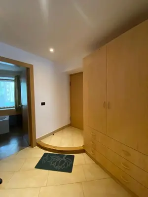a room with a large cabinet and a rug at El Polse - Appartmento per 5 persone in Ziano di Fiemme