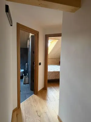 a room with a bed and a door to a bedroom at Alloggio per Milano-Cortina 2026 a ValdiFiemme in Carano