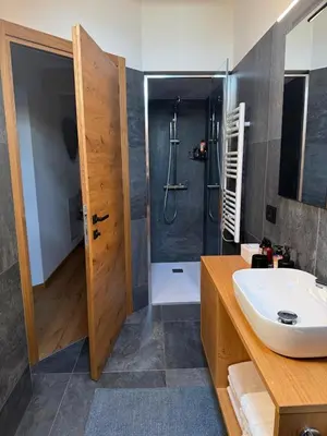 a bathroom with a sink and a shower at Alloggio per Milano-Cortina 2026 a ValdiFiemme in Carano