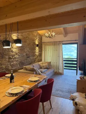 a living room with a table and a couch at Alloggio per Milano-Cortina 2026 a ValdiFiemme in Carano