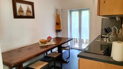 a kitchen with a wooden counter top in a room at El Zirum Boscoverde in Sottoguda