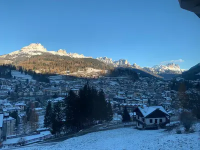 a view of a town with snow covered mountains at Ciasa Soppelsa 2 in Moena