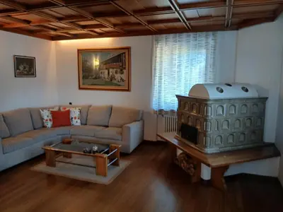 a living room with a couch and a wood stove at Ciasa Soppelsa 2 in Moena