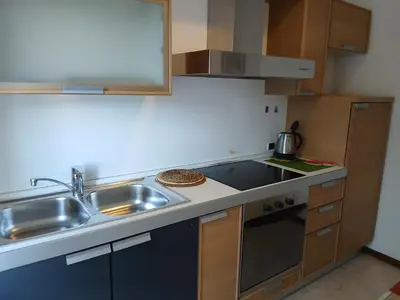 a small kitchen with a sink and a stove at Ciasa Soppelsa 2 in Moena