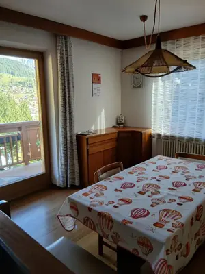 a bedroom with a bed and a large window at Ciasa Soppelsa 2 in Moena