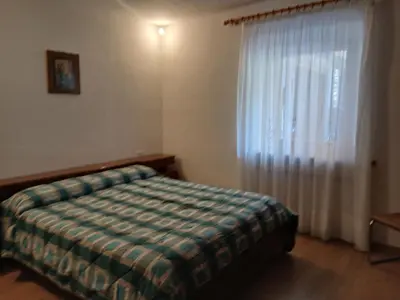 a bedroom with a bed and a window at Casa Soppelsa 1 in Moena