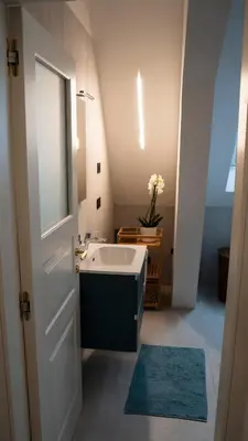 a bathroom with a sink and a mirror at Talvera Dream - City center, Rooftop, Garage & Jacuzzi in Bolzano