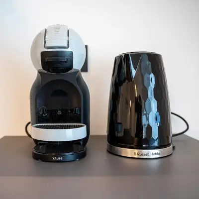 a coffee maker and a toaster sitting on a table at Talvera Dream - City center, Rooftop, Garage & Jacuzzi in Bolzano