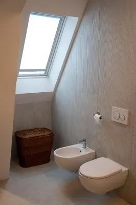 a white sink with a bottle of soap and a plant at Talvera Dream - City center, Rooftop, Garage & Jacuzzi in Bolzano