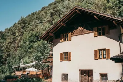 a house with windows on the side of a mountain at Dhea's Little House in Bolzano