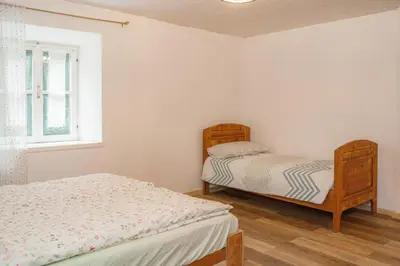 a bedroom with two beds and a window at Dhea's Little House in Bolzano