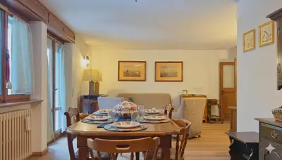 a dining room with a table and chairs at Homeby, Ca' Del Molin in Cortina dʼAmpezzo
