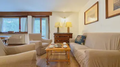 a living room with a couch and chairs and a table at Homeby, Ca' Del Molin in Cortina dʼAmpezzo