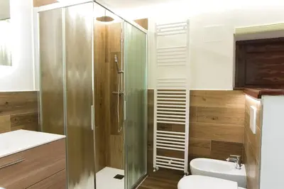 a bathroom with a shower and a toilet and a sink at Dolomites Garden Flat near Cortina in Villanova