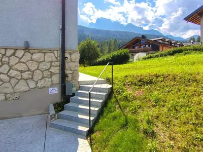 a set of stairs leading up to a building at Dolomites Garden Flat near Cortina in Villanova