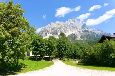 a dirt road with a mountain in the background at Dolomites Garden Flat near Cortina in Villanova