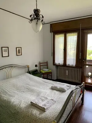 a bedroom with a bed with a white bedspread at Apartment with Dolomites view in Cortina dʼAmpezzo