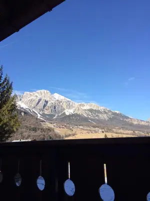 a view of a snow covered mountain from a window at Apartment with Dolomites view in Cortina dʼAmpezzo