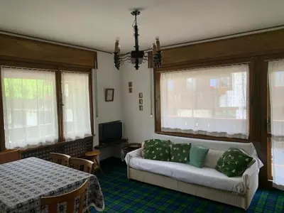 a living room with a couch and a table at Apartment with Dolomites view in Cortina dʼAmpezzo